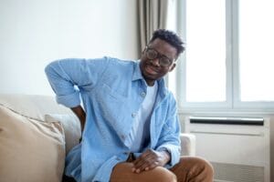 man with back pain after a delayed car accident injuries